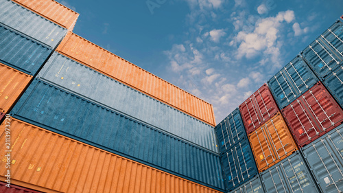Colorful Shipping Containers Stacked Against Blue Sky