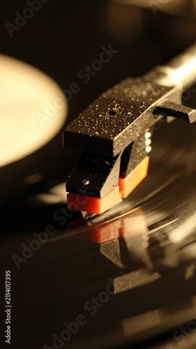 Close-up of a vintage turntable needle playing a vinyl record with warm atmospheric lighting for music lovers