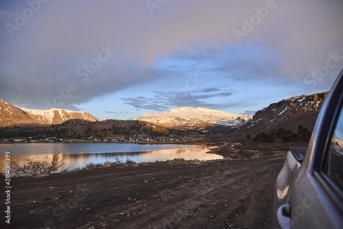 Winter landscape in Caviahue, Neuquen, Argentina. The mountains, bathed in morning light, are reflected on the surface of the lake.