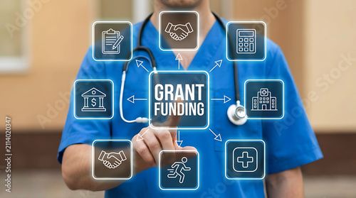 Doctor touching grant funding text on futuristic virtual medical display