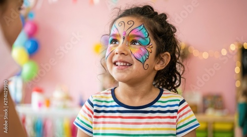 Little girl with butterfly face paint smiling at a birthday party
