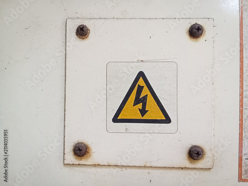 Konstfotografi Close up of a yellow triangle high voltage electrical hazard warning sign on a w