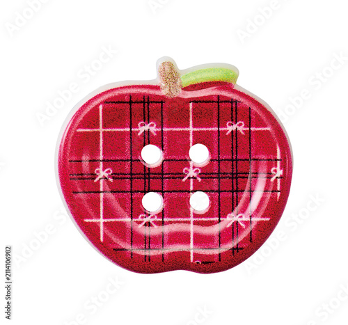 Red plaid apple shaped sewing button with green stem isolated on white background