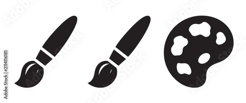 Three black depicting two paint brushes and an artist color palette with paint blobs, isolated on a plain white background for