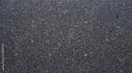 Honed dark granite slab with fine speckle and deep charcoal tone