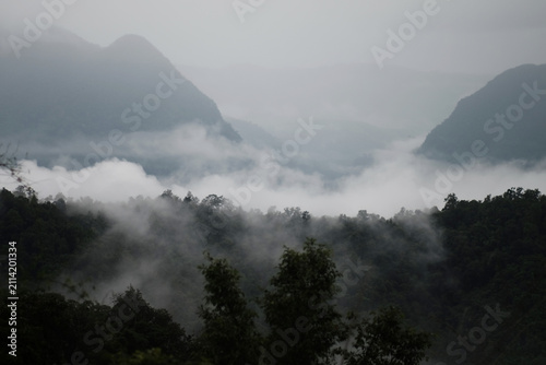 Photography Beautiful silhouette mountains with mist and foggy cloud on valley hill with gre