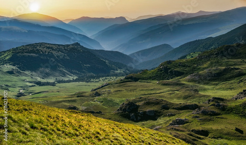 Carpathian mountains landscape. mMuntains  and hills at the sunset shiny  sky in Romania