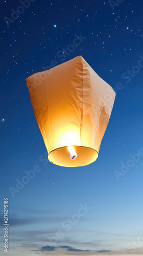 Sky lantern star night sky glowing paper flame floating blue twilight celebration abstract art of glowing paper sky lantern rising into starry