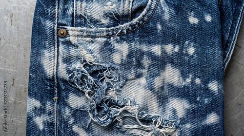 Distressed blue denim jeans close-up