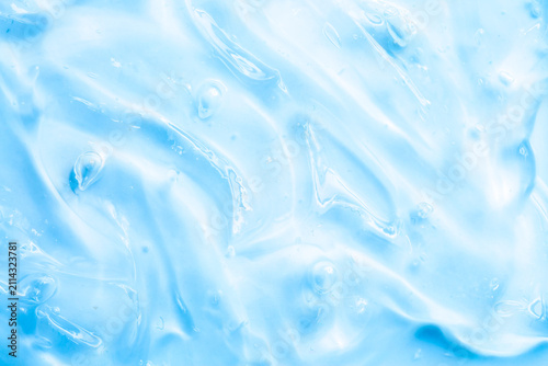 Cosmetic gel, serum, clear sample with a blue tint, close-up. Liquid cream with a foaming texture. Gel texture of a cosmetic product. Liquid cosmetic lotion for skin care.