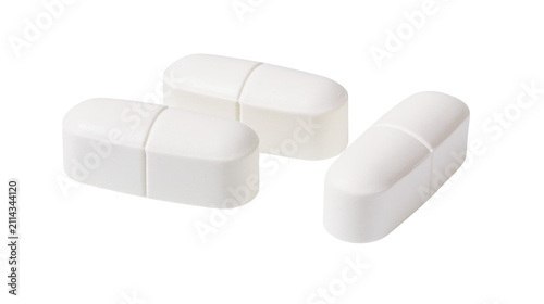 Fotografie Three white oblong pills with score line