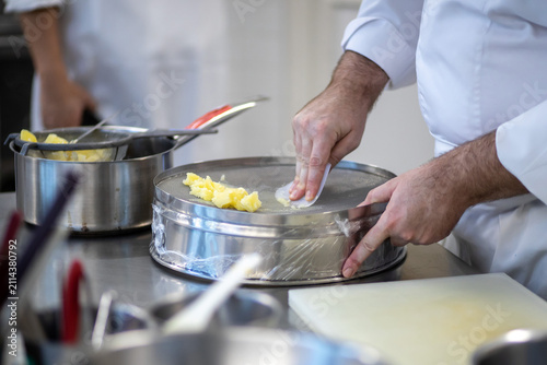 Photography Professional Chef Hand Pressed Mashing Boiled Potatoes Through Drum Sieve Pot wi