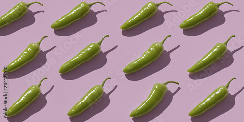 An array of vibrant green chili peppers arranged in a repeating pattern on a pastel purple background. The peppers have a glossy sheen and cast soft shadows, creating a visually dynamic composition