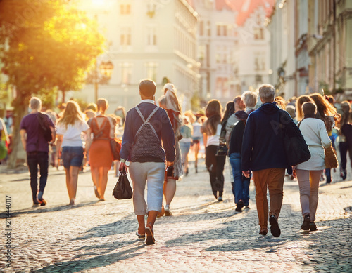 Crowded European Street Scene with People Strolling in Warm Evening Light