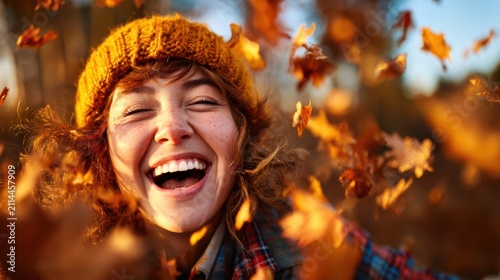 This captivating image showcases a joyful woman surrounded by falling autumn leaves, expressing pure happiness and connection to nature in a vibrant outdoor setting.