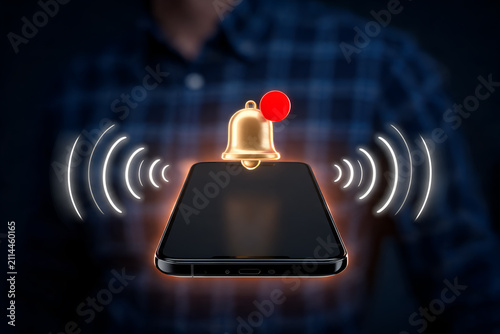 Businessperson holding modern smartphone displaying notification bell and sound waves alerts digital interface communication alert