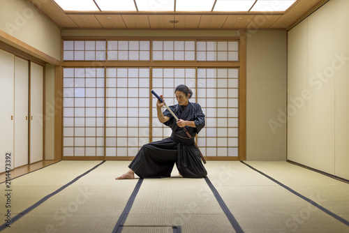 Obraz na płótnie Samurai warrior with katana sword  training ancient japanese martial arts in a t
