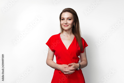 Young smiling girl in red dress. Isolated on white background.