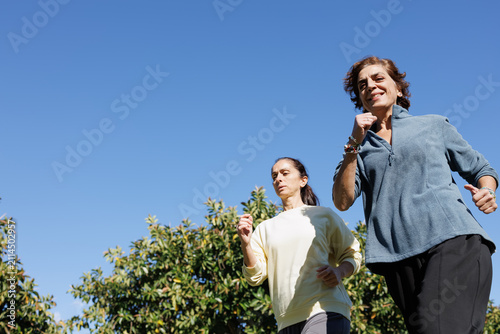 Women jogging outdoors together feeling active and healthy