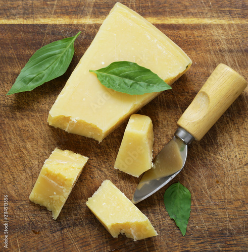 Hard Parmesan cheese on a wooden board