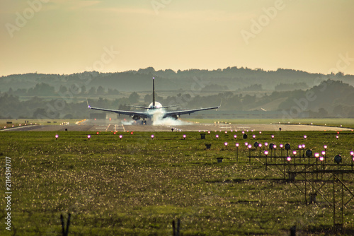 Obraz na plátně Passenger airplanes taxiing, taking off and landing at an airport