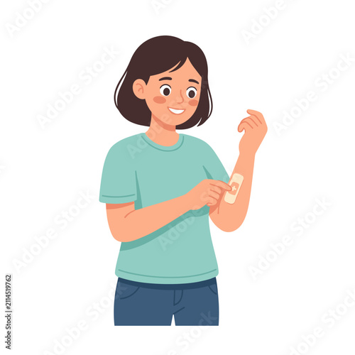 Woman applying medicated patch on her arm and smiling in casual wear  