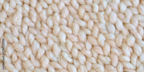 Macro close up of a soft chunky white knitted fabric texture for cozy winter textile background