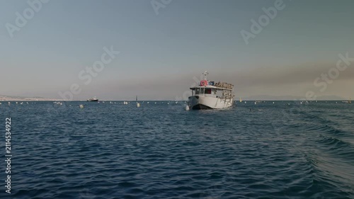A boat harvesting mussels from a farm in the Gulf of Naples along the Mediterranean coast.