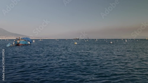 A boat harvesting mussels from a farm in the Gulf of Naples along the Mediterranean coast.