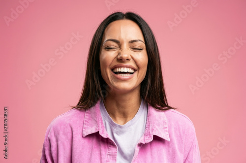Obraz na plátně A burst of pure joy captured in this portrait of a young woman laughing heartily