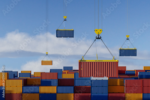 Multiple cranes operating in busy container port and freight yard
