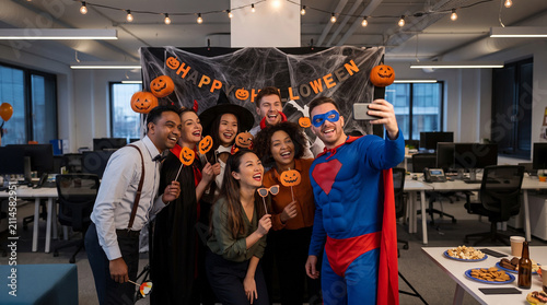 Manager and employees celebrate Halloween in costumes at office party