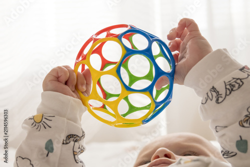 Baby Holding Colorful Sensory Ball During Early Development Play