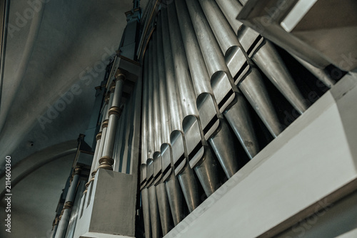 Bild auf Leinwand Low-angle view of towering church organ pipes inside a historic sanctuary, highl