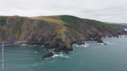 High-angle view on the dramatic, steep rocky cliffs and rugged coastal headland at Fast Castle Head, showcasing the geological formations and North Sea in Berwickshire, Scotland.