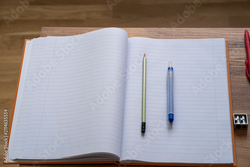 Open blank notebook with school supplies