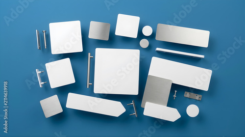 A collection of assorted blank white and metallic objects arranged on a vibrant blue background representing a variety of shapes and sizes