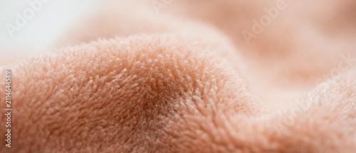 Macro shot of soft peach fleece fabric texture background