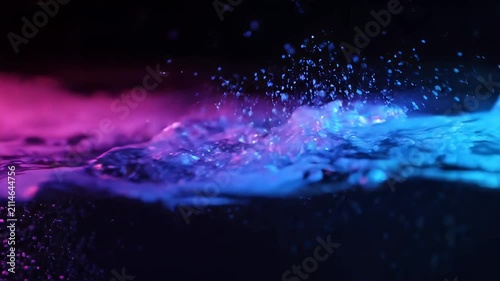 Water surface with pink and blue neon lighting and small bubbles