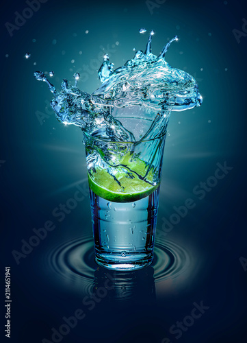 Lime Slice Splashing Into Glass of Water with Dramatic Crown Splash