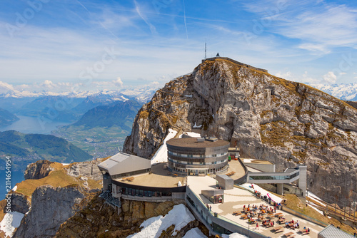 Cuadro en lienzo Aerial view of a luxury hotel, restaurants, and viewing platforms on the rocky summit of Pilatus mountain under a bright blue sky