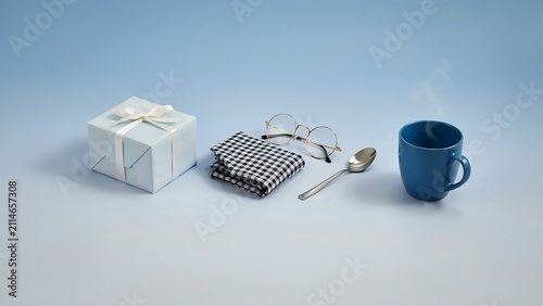 Minimalist gift box with glasses, napkin, spoon and coffee mug