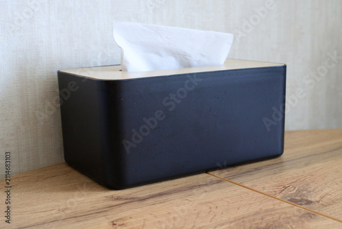 Konstfotografi Black, minimalist paper napkin container sits on a table