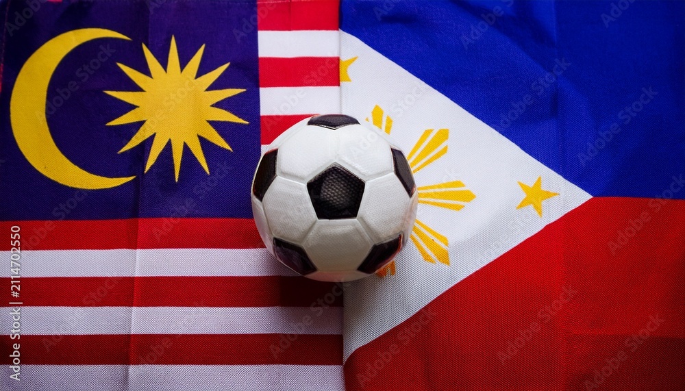 Fototapeta premium soccer ball between Malaysia flag and Philippines flag