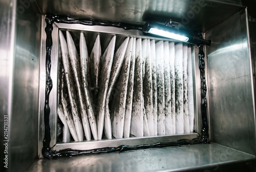 Dirty air filter discovered during an HVAC maintenance inspection revealing a heavily soiled pleated ventilation filter