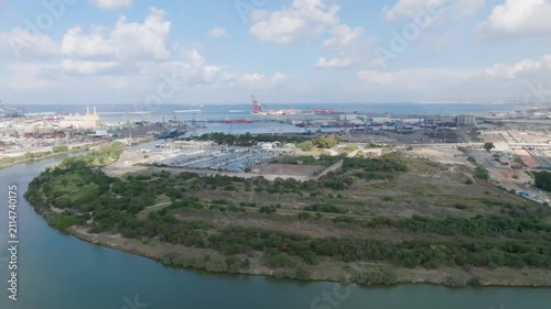 Aerial view of Haifa Port, the marina, and the Kishon River landscape under a partly cloudy sky
