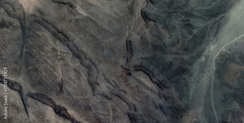 Obraz na plátně Satellite view of converging desert canyons and a circular eroded dome in the Sahara Desert North Africa within scalloped badlands terrain