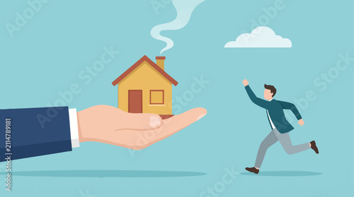 Фотография Man chasing dream home offered by a helping hand, real estate concept