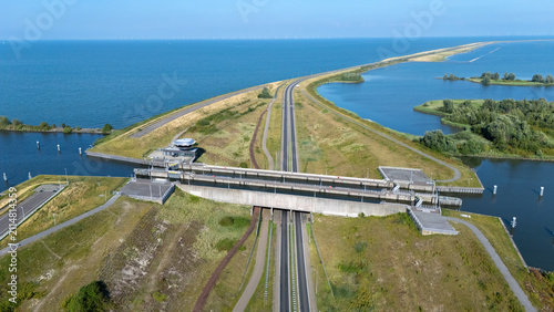 Aerial view of Naviduct Krabbersgat with the dike, road and surrounding water in the Netherlands. Drone photograph showing Dutch water infrastructure, lock system, causeway and landscape from above.