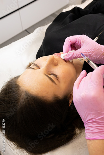 A picture of a very beautiful and attractive young lady, a portrait showing how satisfied she is after the lip rejuvenation procedure. This look is very popular on the market, attractive to clients.